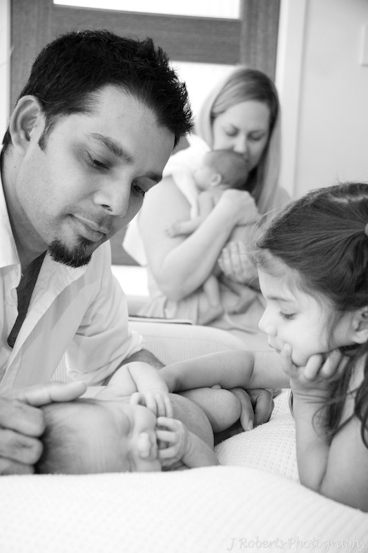 Family with newborn twins interacting - newborn portrait photography sydney